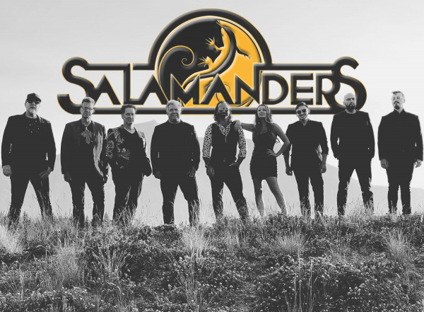 group picture of Salamanders band with 9 people and their logo behind them